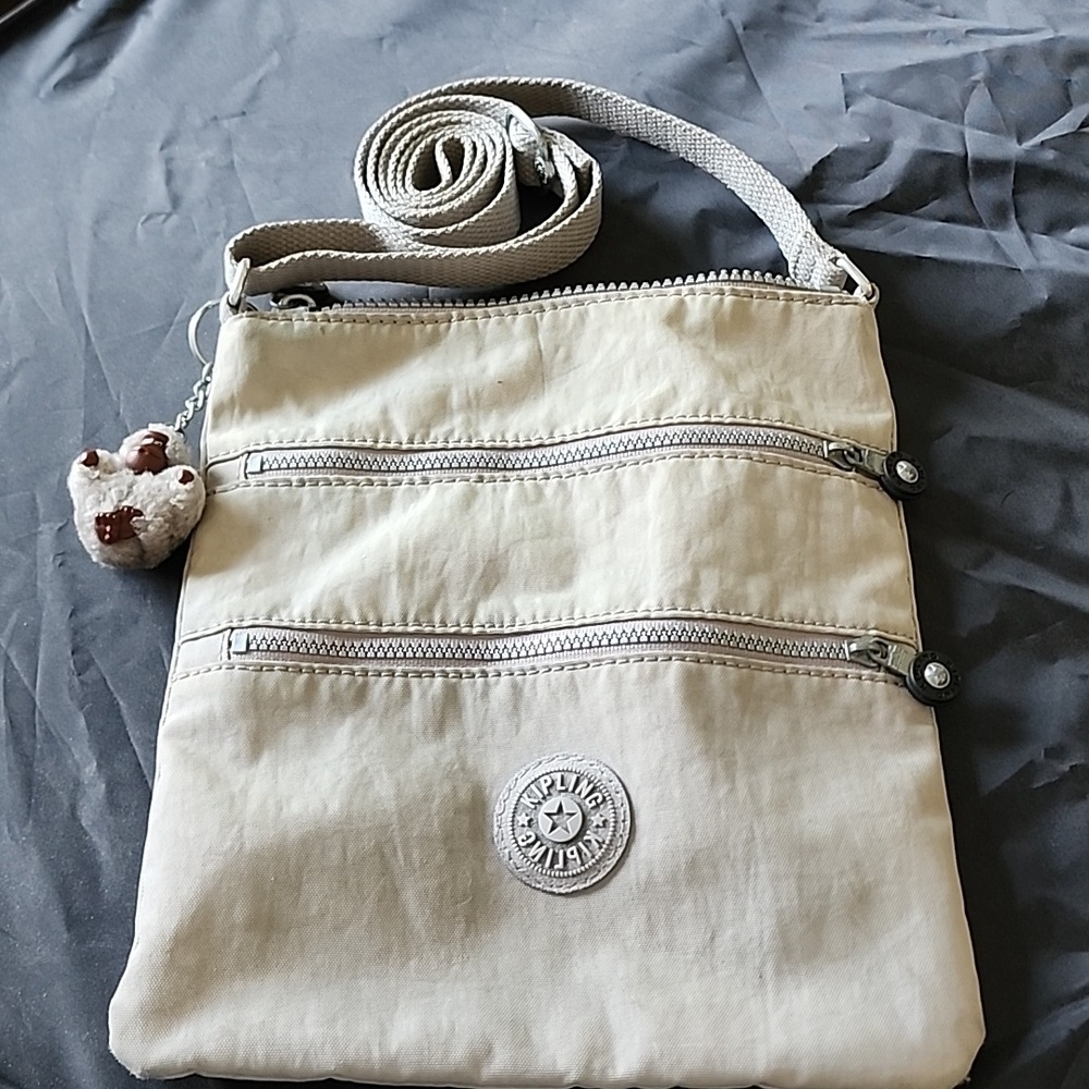 Well loved Kipling gray crossbody purse with‎ gorilla charm